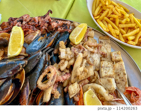 Seafood platter with musselspus, squid, squidpus and French fries a Marsaxlokk cafe, Malta Seafood platter with musselspus, squid, squidpus and French fries a Marsaxlokk cafe, Malta 114200263