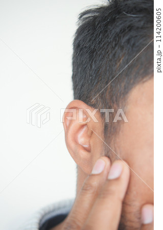 young man having ear pain touching his painful ear , young man having ear pain touching his painful ear , 114200605