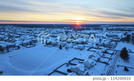 Aerial Winter Sunrise Over Snowy Suburban Neighborhood 114200910