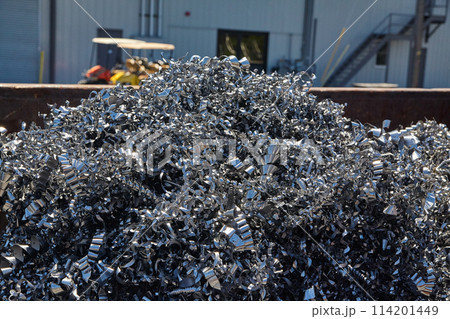 Industrial Scrap Metal Pile with Machinery Background Industrial Scrap Metal Pile with Machinery Background 114201449
