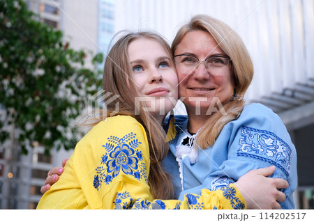 Two Ukrainian women mother and daughter look to the future Multi-colored embroidered shirts symbols of Ukraine 114202517