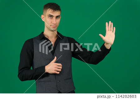 spy emotions of a handsome man guy on a green background chromakey close-up dark hair young man spy emotions of a handsome man guy on a green background chromakey close-up dark hair young man 114202603