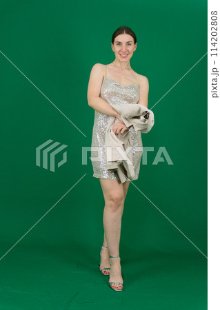 Fashion woman in evening dress portrait. Female young model. Studio isolated , green background .Long hair. 114202808