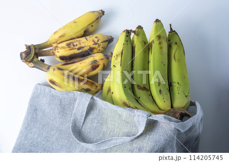Bunch of bananas in a textile bag on a white background. 114205745