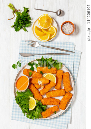 crispy fried breaded fish sticks on a plate 114206105
