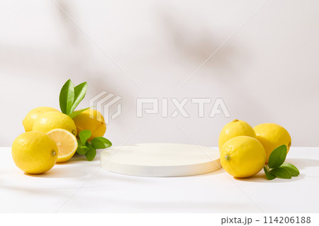An blank pedestal placed in the center of photo, surrounded by some fresh lemons. Lemon juice has many uses, from culinary to medicinal, provides the fragrance for perfumes, soaps, and skin creams An blank pedestal placed in the center of photo, surrounded by some fresh lemons. Lemon juice has many uses, from culinary to medicinal, provides the fragrance for perfumes, soaps, and skin creams 114206188