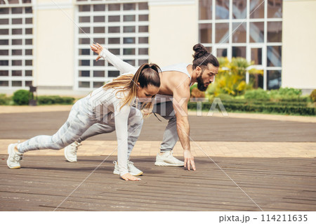 Happy Couple Exercising In Park 114211635