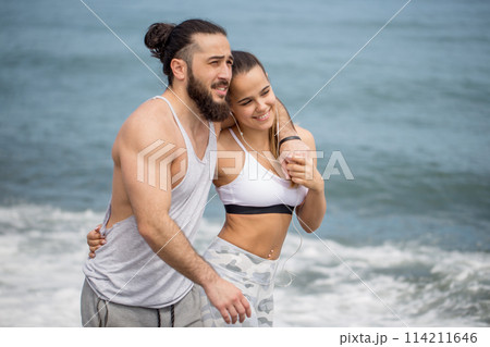 Happy afro american couple having fun together on a beach 114211646