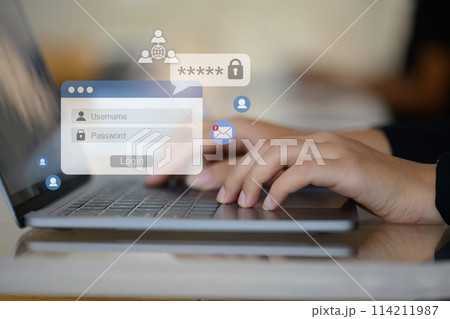 Woman hands typing username and password on her laptop to access account on website 114211987