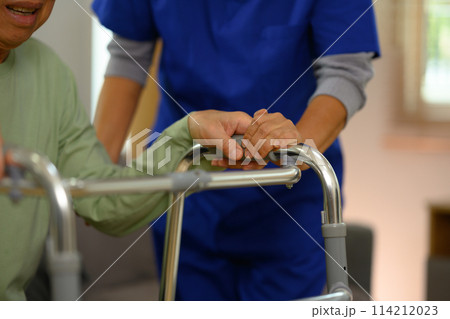 General practitioner holding hands comforting upset senior patient. Elderly healthcare concept 114212023