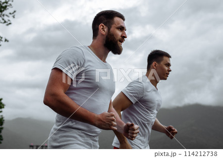 Morning workout, sportive men running in mountains living healthy lifestyle 114212738