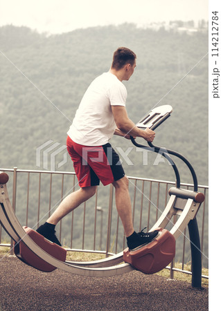 Man performs sport exercise, fitness street workout. Healthy Lifestyle. Man performs sport exercise, fitness street workout. Healthy Lifestyle. 114212784