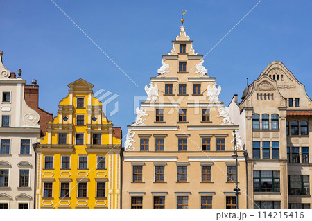 Beautiful colorful facades of antique building at Wroclaw, Poland. Polish landmark in the historic center of town. Clear blue sky 114215416