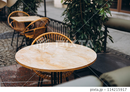 Outdoor street cafe tables ready for service. Modern Empty cafe terrace with table and chair, morning time. Food concept. Cafeteria, Outside Trattoria Outdoor street cafe tables ready for service. Modern Empty cafe terrace with table and chair, morning time. Food concept. Cafeteria, Outside Trattoria 114215917
