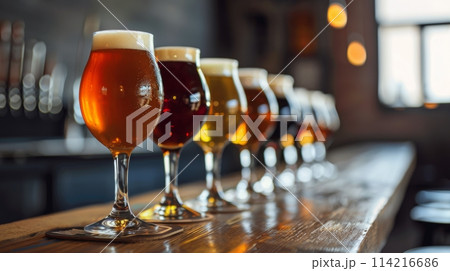 Variety of beers lined up on a rustic bar counter, inviting you to try something new 114216686