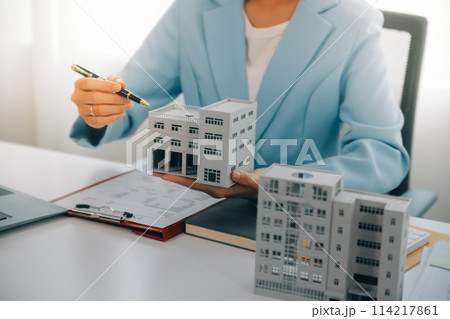 Real estate agent talked about the terms of the home purchase agreement and asked the customer to sign the documents to make the contract legally, Home sales and home insurance concept. 114217861