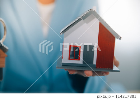 Real estate agent talked about the terms of the home purchase agreement and asked the customer to sign the documents to make the contract legally, Home sales and home insurance concept. Real estate agent talked about the terms of the home purchase agreement and asked the customer to sign the documents to make the contract legally, Home sales and home insurance concept. 114217883