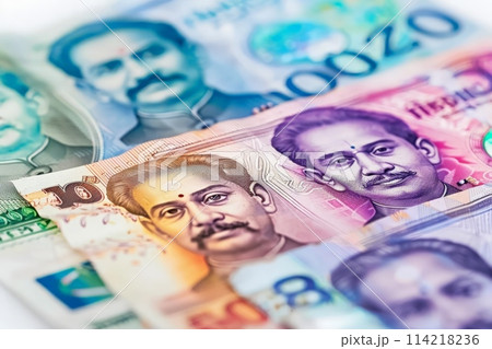 An artistic arrangement of stacked Indian currency notes creating a pile, showcasing wealth and financial abundance. 114218236