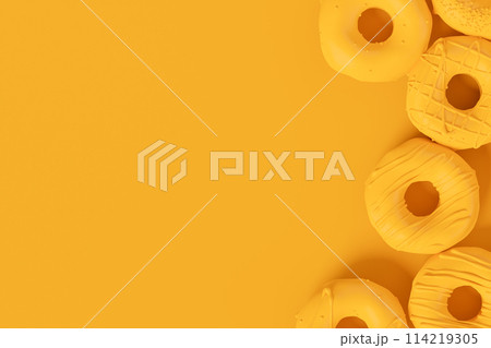 Isometric view of glazed donut with sprinkles on plain monochrome yellow color 114219305