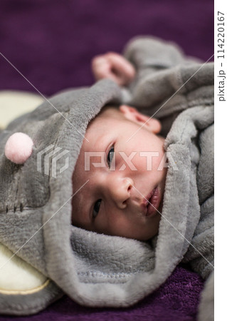 One month old baby girl on soft blanket 114220167