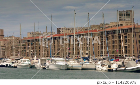 Seafront part of the city behind the sailboats and motorboats in marina. Vieux-Port district of Marseille, France 114220978