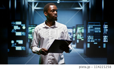African american engineer doing maintenance in data center providing vast computing resources and storage, enabling artificial intelligence to process massive datasets for training and inference 114221258