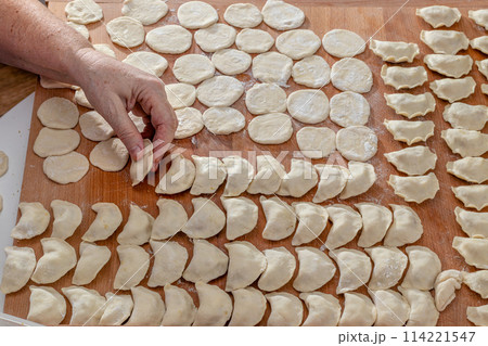 Dumpling. Woman hands are making a damp dumpling.  114221547