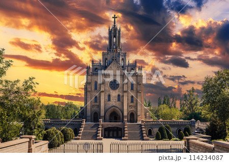 Cathedral of Sacred Heart of Jesus in Tashkent in Uzbekistan. Facade of ancient Church on background of cloudy dramatic sky at sunrise in summer Cathedral of Sacred Heart of Jesus in Tashkent in Uzbekistan. Facade of ancient Church on background of cloudy dramatic sky at sunrise in summer 114234087