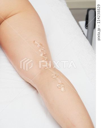 Beautician applying wax before Removing Hair Of Young Woman's body 114238829