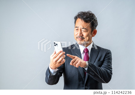 スマホを使うミドル男性。 114242236