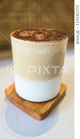 Fresh iced coffee in glass with frothy cream for your design, Food concept in style, copy space 114242331
