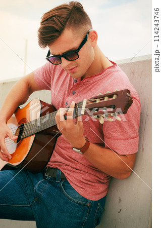Trendy guy with guitar outdoor Trendy guy with guitar outdoor 114243746