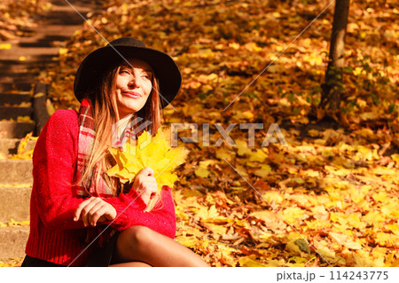 Woman relaxing in autumn fall park Woman relaxing in autumn fall park 114243775