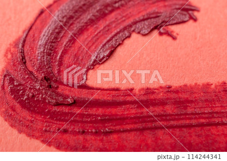 red brush stroke on orange paper, abstract background, hand painted 114244341