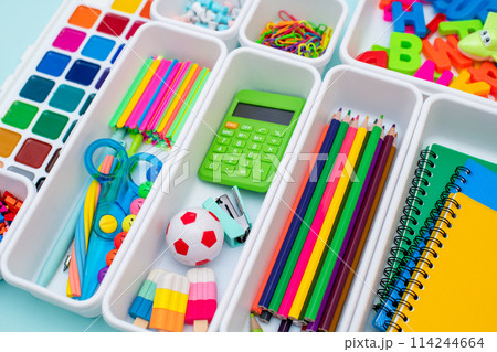 School supplies.Concept back to school. colored stationery is arranged in white organizers. Creative Drawer Organizing. Storage office supplies 114244664