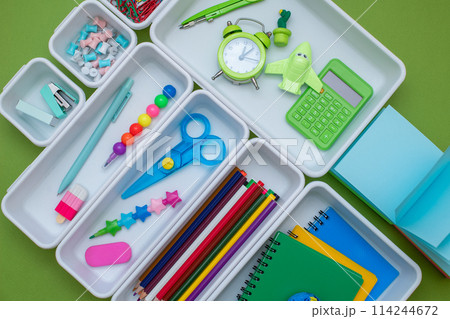 School supplies.Concept back to school. colored stationery is arranged in white organizers. Creative Drawer Organizing. Storage office supplies School supplies.Concept back to school. colored stationery is arranged in white organizers. Creative Drawer Organizing. Storage office supplies 114244672
