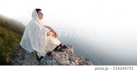 Young man sitting on the rock Young man sitting on the rock 114244725