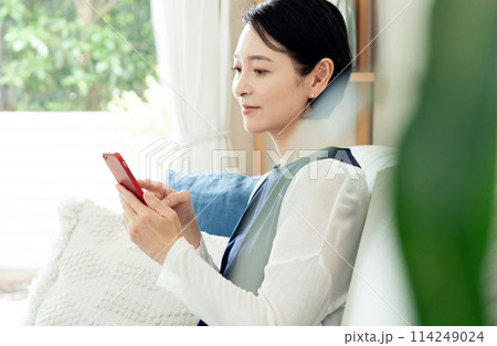 スマホを操作するミドル女性 スマホを操作するミドル女性 114249024