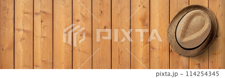 Straw Hat on Wooden Background. File with Clipping Path. 114254345