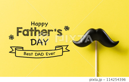 Father's day concept. Black moustache and the text on yellow paper background. 114254396