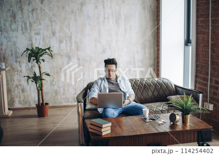 Unshaven Hipster working Laptop modern Interior Design Loft Office. 114254402