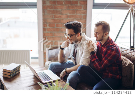 Homosexual partners working at office desk, relationships and business concept Homosexual partners working at office desk, relationships and business concept 114254412
