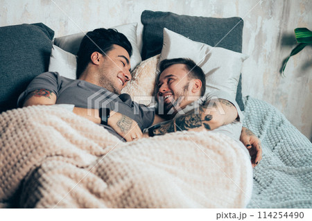 Positive delighted non-traditional couple sleeping together Positive delighted non-traditional couple sleeping together 114254490