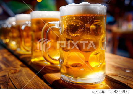 Beer mugs on a wooden table in a pub or restaurant. Beer mugs on a wooden table in a pub or restaurant. 114255972