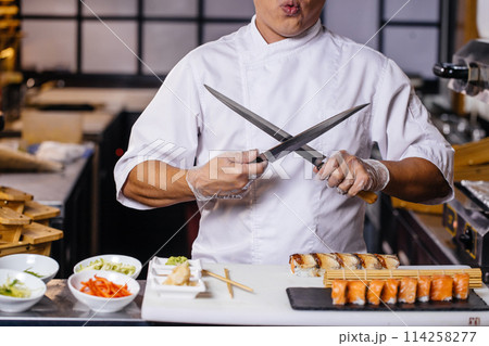 man in white uniform with crossed knives 114258277