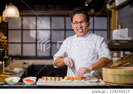 laughing Asian chef loves his job 114258317