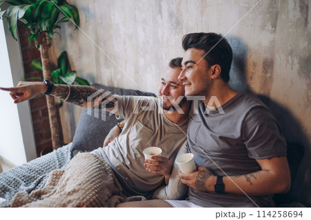 Perfect morning begins with lover and coffee in bed. Two guys resting in bed. Perfect morning begins with lover and coffee in bed. Two guys resting in bed. 114258694
