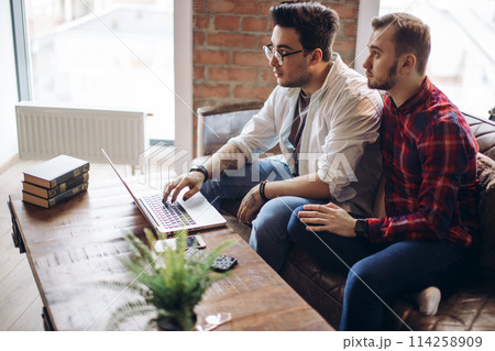 Homosexual partners working at office desk, relationships and business concept Homosexual partners working at office desk, relationships and business concept 114258909