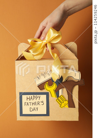 A gift for father, for the holiday, on an orange background. 114259246