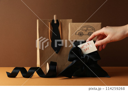 Concept of international father's day, gifts and greetings, on a brown background. 114259268